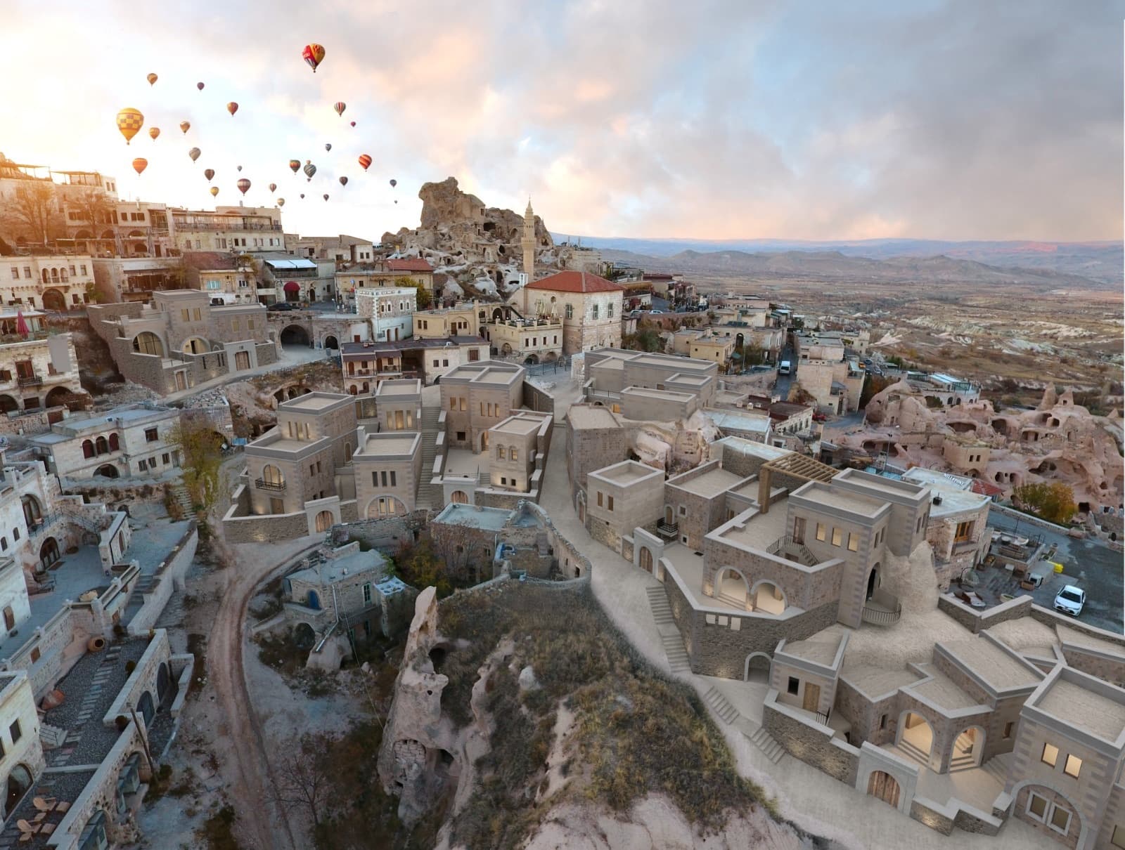 Hot-air balloons over the Arsis property and Uçhisar castle at sunset
