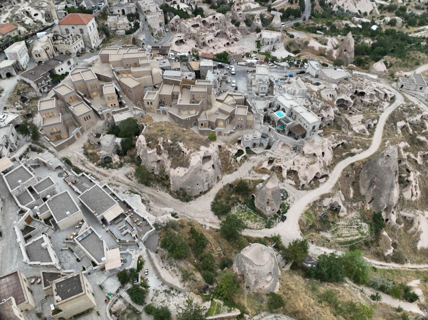 Aerial view of the property, its pool and the surrounding fairy chimneys